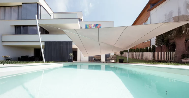 Flexibles Sonnensegel über moderner Terrasse mit Pool